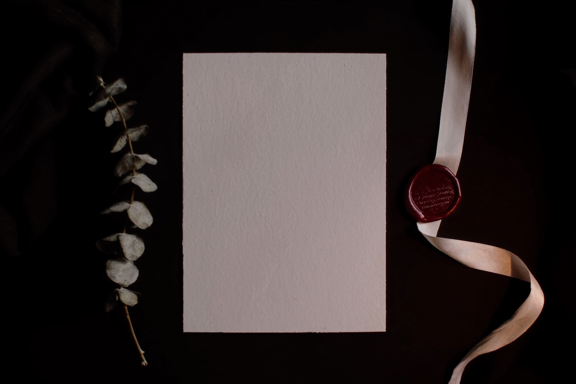 A blank invitation card with a wax seal